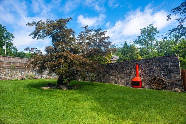 Walled courtyard with room to relax on the grass or around the fireplace