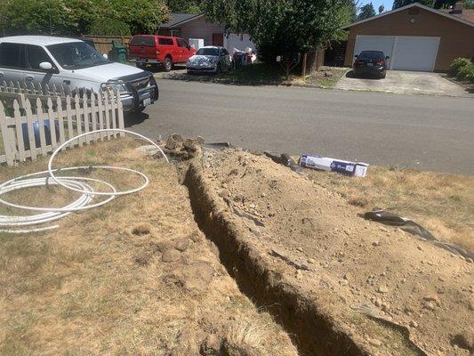 Red cedar plumbing dig like 15 inches deep and like 70 feet to install a new Pex A main water line pipe from the water meter.