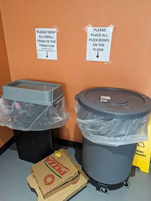 Trash cans in corner of store