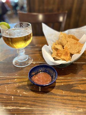 The table was a little beat up , but the chips and salsa was good .