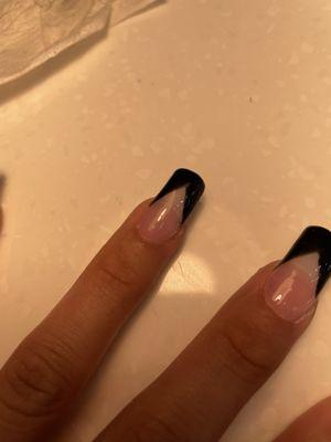 She tried to sand off where she made a mistake but left it chipped with black residue on the clear part