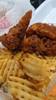 Chicken tenders and garlic parmesan waffle fries.