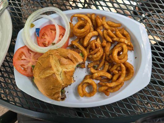 Ground beef burger and curly fries.