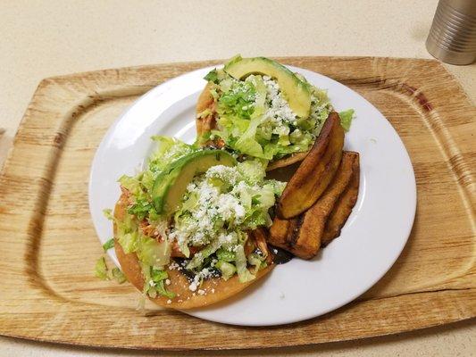 Achiote Marinated Chicken Tostadas with Shaved Lettuce, Black Beans, Avocado, Cotijo Cheese and Plantains