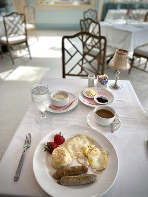 The Gloriette Breakfast - fried eggs, apple chicken sausage, brie and cream cheese grits, homemade biscuit.