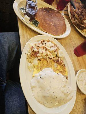 Country fried steak and eggs with a side of pancakes