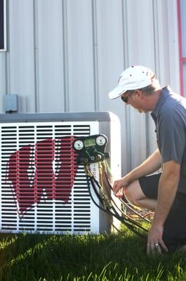 A DJI Technician performing maintenance tests on an A/C unit.