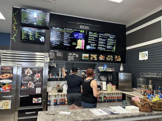 Front counter where you place your order and pay. They have digital and paper menus.