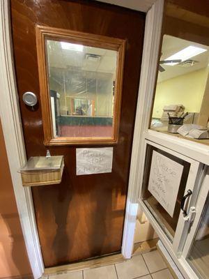 Covid precautions. Door on the left has a spot for payments. Cabinet on the right is the food pass through.