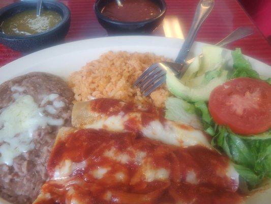 Enchiladas rojo with beef, onions, and chiles.  Avocado and fresh salad.  Homemade refried beans.