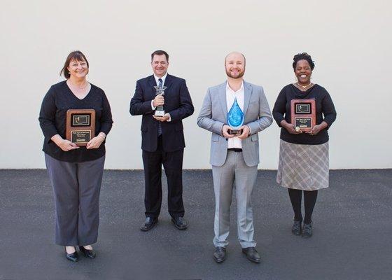 Our team with awards for outstanding client service