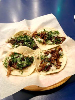 Bistec/steak, Adobada/marinated pork, Carnitas/roasted pork and Al Pastor/marinated pork with pineapple and grilled onions.