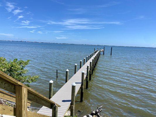 Dock on the river with Trex decking and white piling caps.