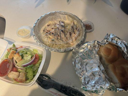 Fettuccine Alfredo with chicken , house salad & bread