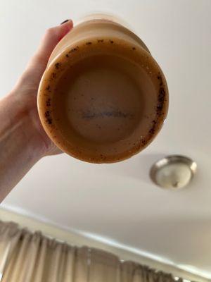 latte with coffee grounds in the cup