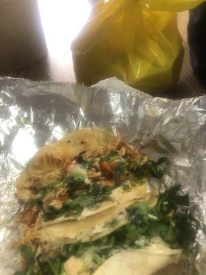 2 chicken tacos with something hot on it.