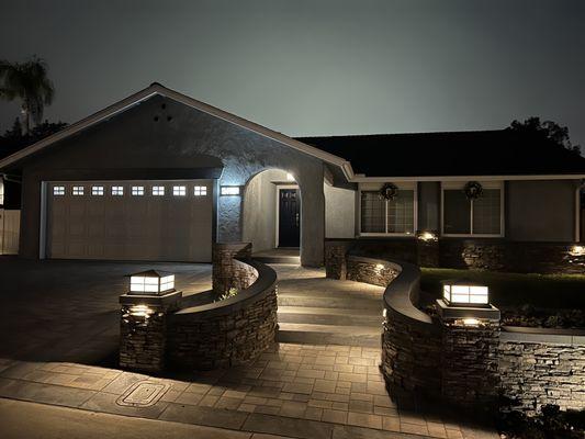 New front entry with interlock pavers and chemical finish concrete border.  Also outdoor lighting.