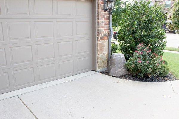 Fake rock outside covering a water filtration system installation for the whole house. Each water fixture has filtered "bottl...