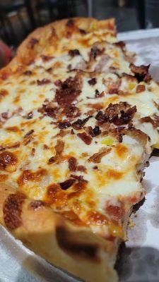 Butter crust pizza with bacon sausage and pepperoncinis