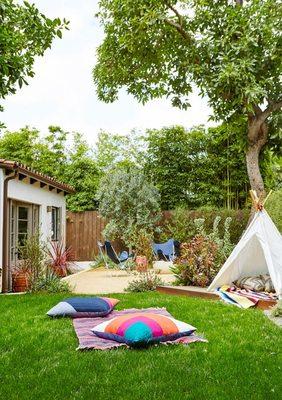 Mediterranean eclectic back yard.  Designed to give space for both children's play area as well as adult entertaining area with firepit.