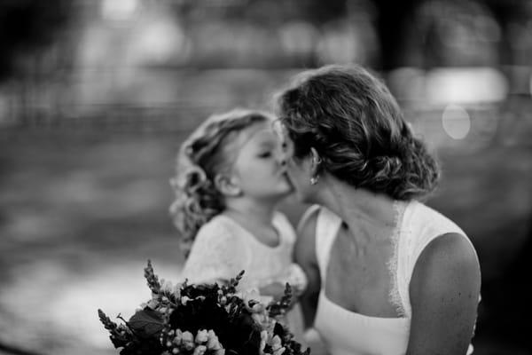 A congratulatory kiss was given to this bride by one of her littlest guest.