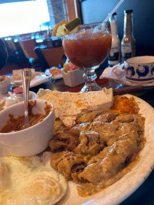 Vaccaro chicken fried steak, fried eggs, sides of hash browns, refried beans, flour tortillas. Bloody Mary