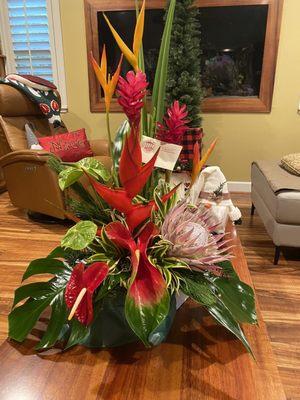 King protea, heliconia, red ginger, red/green/tropical sunrise anthurium, tropic fleur, monstera leaves, song of Jamaica, hala leaves.