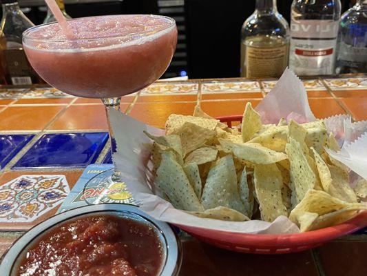 Complementary chips and salsa out of this world. That is a non-alcoholic frozen raspberry margarita. Wonderful!