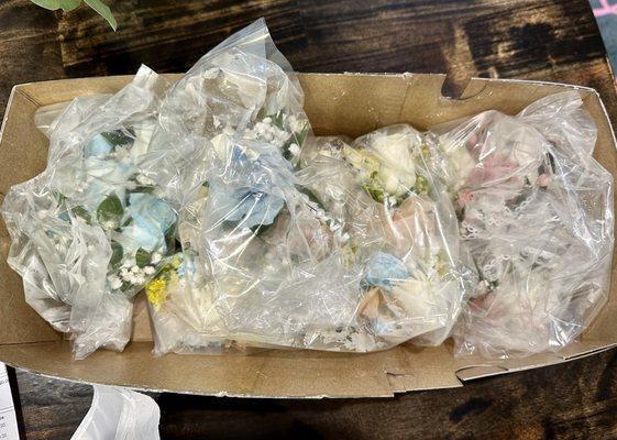 My corsages and boutonnières (wrapped in plastic)