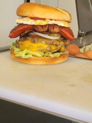 The half of pound Mr Big Burger  beef Patty, Veggies, Tillamook Cheese, Bacon, Hot links, egg, Mushroom, Mayonnaise, ketchup, Mustard.