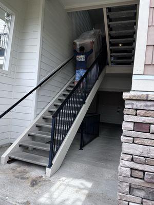 Moving heavy furniture up 3 flights of stairs with care and strength!