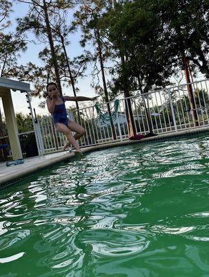 Me jumping in a green pool