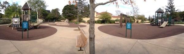 Lil kids on the left; bigger kids on right. Climbing rocks and swings in the middle. All fenced in.