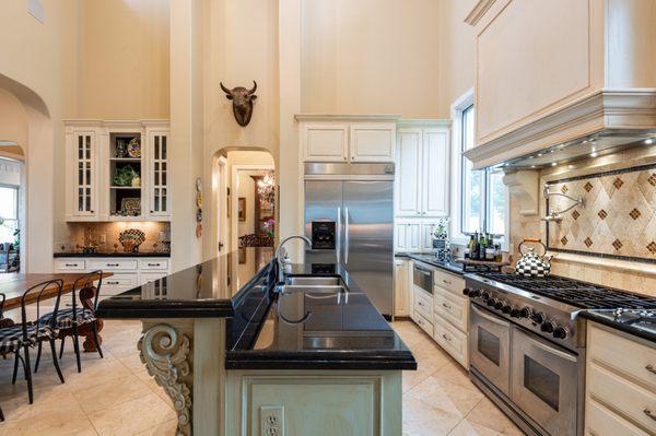 Delight in a chef's kitchen with high-end appliances, island and breakfast bar and Gilmer, TX luxury ranch.