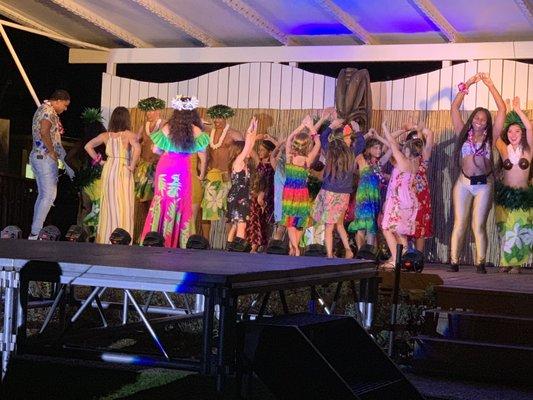 Guests in stage dancing with the natives