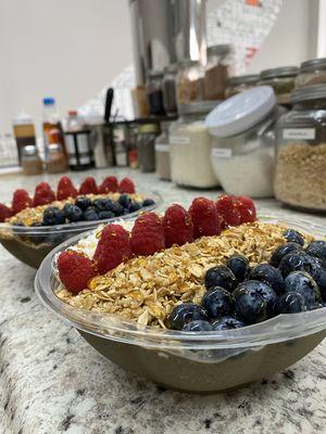 Two custom bowls (power bowls with raspberry and blueberry no banana topping)