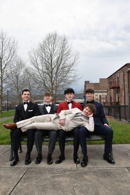 A group of young people wearing prom formalwear