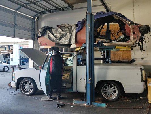 Mechanic working fixing an electrical problem on a Chevy