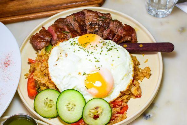 Steak and eggs on top of Thai basil fried rice (brunch)