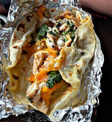 Chicken fajita taco with cheese, onions, & cilantro