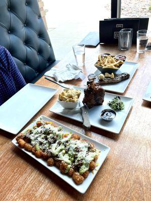 Loaded tots, pork shank, steak and fries