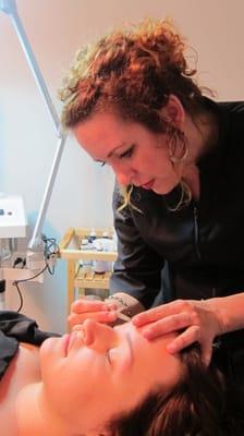 Randi Lynn doing an eyebrow waxing.