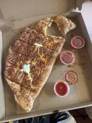 Giant Cheese Calzone. 15$. Incredibly cheesy and thick. Must weigh a couple pounds at least.