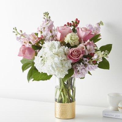 Tickle them pink with this elegant arrangement of roses, alstroemeria, hypericum berries, and carnations set in a gold-dipped vase.