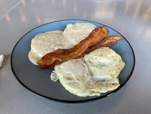 Biscuits and gravy with bacon and eggs