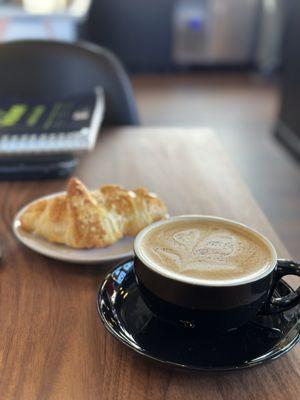 Sower's Cup with oat milk and an almond croissant.