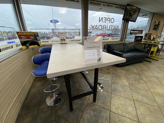 Work center with phone charging station, multiple plug ins and adjustable height seating.