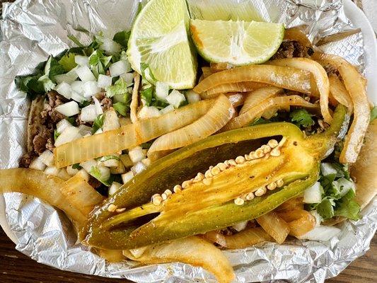 Carne Asada & Al Pastor Tacos with grilled onions & jalapeño