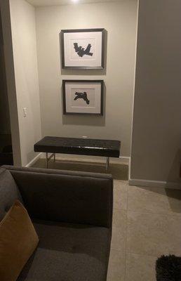 Framed artwork fills a gallery nook in the living room of our new home.