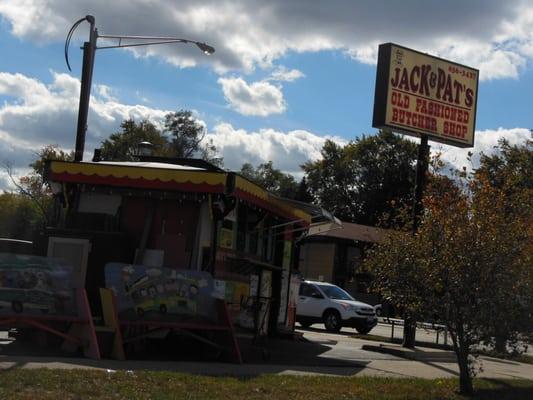 A view of the store's sign and trolley they sell hot dogs and drinks from during the summer months.